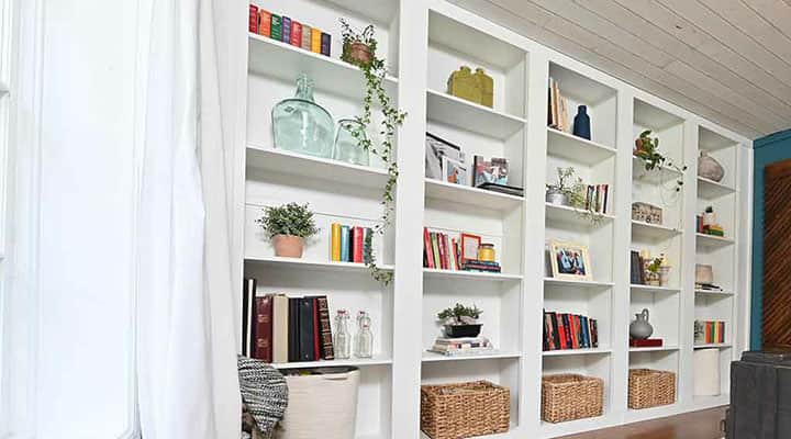 white built-in storage bookshelf in family den